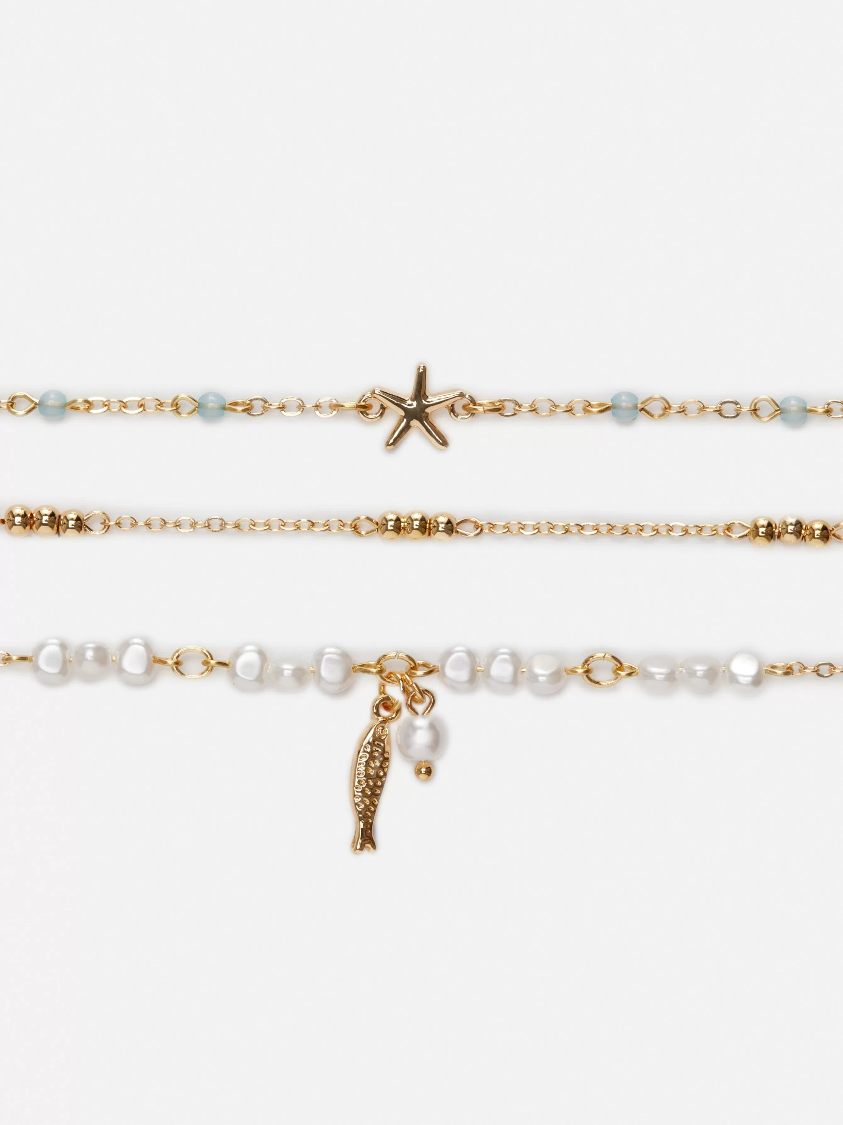 Shop Primark Lot De 3 Chaînes De Cheville à Motifs Bord De Mer Blanc